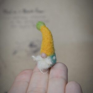 This tiny wool gnome is full of folklore charm! At just 2.5 cm tall, he’s handmade with care — a magical addition to fairy gardens and miniature forest scenes.