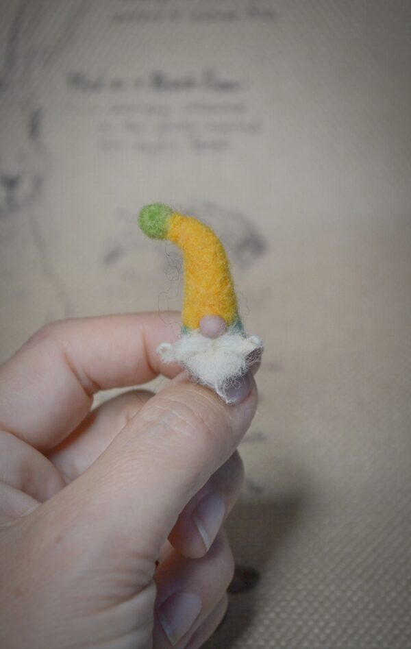 This tiny wool gnome is full of folklore charm! At just 2.5 cm tall, he’s handmade with care — a magical addition to fairy gardens and miniature forest scenes.