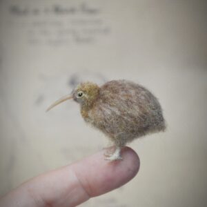 This tiny kiwi bird is handmade from wool with a long beak and soft rounded body. A rare felted miniature for bird lovers and New Zealand-themed collections.