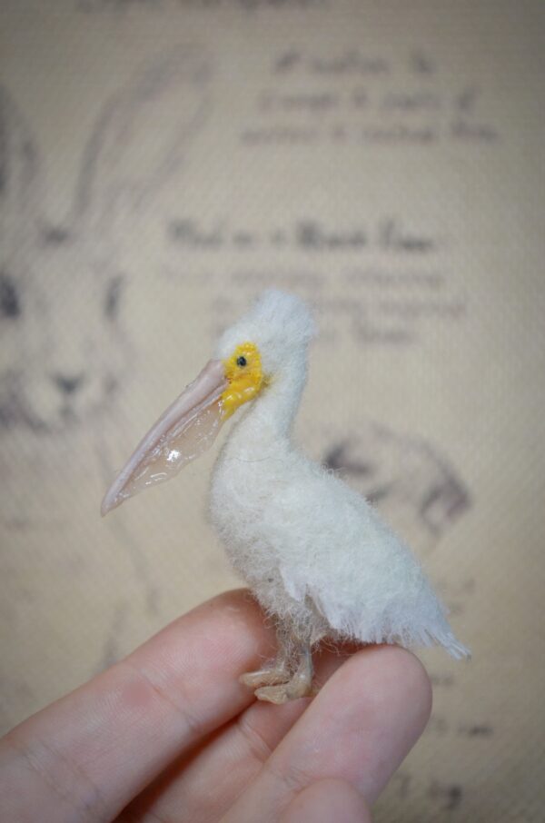 Needle felted pelican miniature with movable neck. Handmade wool bird collectible for dollhouses, dioramas, and bird lovers.