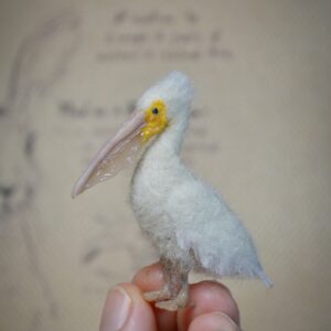 Needle felted pelican miniature with movable neck. Handmade wool bird collectible for dollhouses, dioramas, and bird lovers.