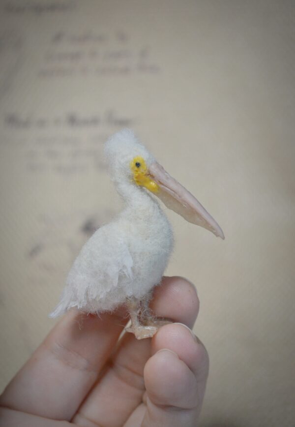 Needle felted pelican miniature with movable neck. Handmade wool bird collectible for dollhouses, dioramas, and bird lovers.