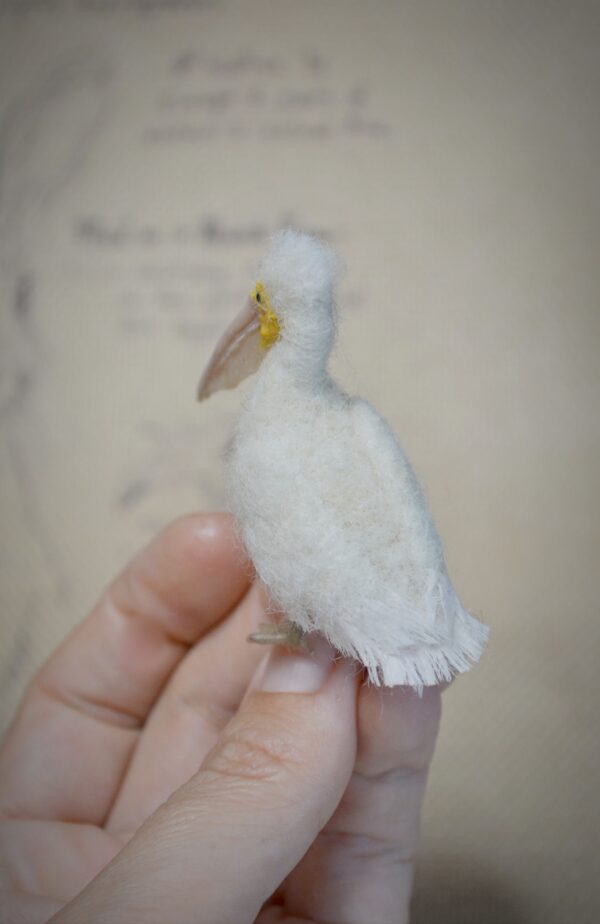 Needle felted pelican miniature with movable neck. Handmade wool bird collectible for dollhouses, dioramas, and bird lovers.