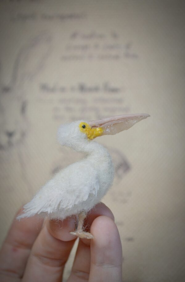 Needle felted pelican miniature with movable neck. Handmade wool bird collectible for dollhouses, dioramas, and bird lovers.