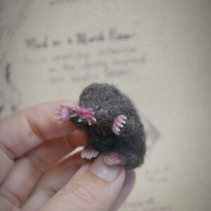 Handmade needle felted mole with poseable body, bendable legs, and turning head. Unique wool woodland miniature for collectors and dollhouse scenes.