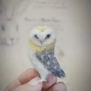 Unique handmade owl miniature with head turned back, 5 cm tall. Needle felted from wool, perfect for collectors, bird lovers, and dollhouse displays.