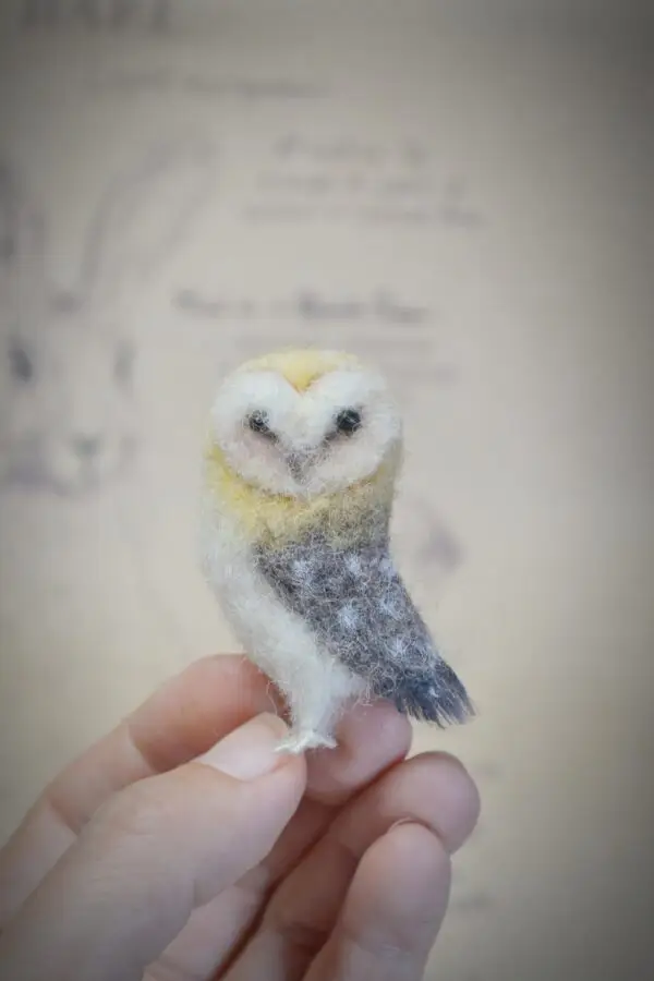 Unique handmade owl miniature with head turned back, 5 cm tall. Needle felted from wool, perfect for collectors, bird lovers, and dollhouse displays.