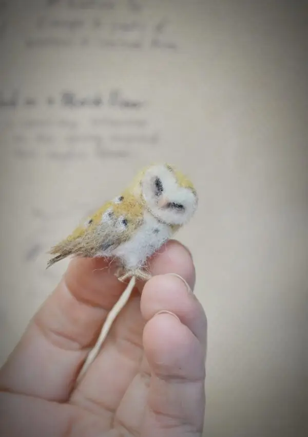 Adorable handmade owl miniature with tilted head, 5 cm tall. Needle felted from wool, perfect for collectors, bird lovers, and dollhouse decor.