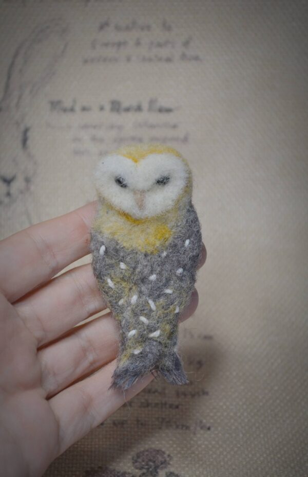 Handmade needle felted owl brooch. A unique wool accessory with secure pin, perfect for jackets, scarves, and as a gift for owl lovers.