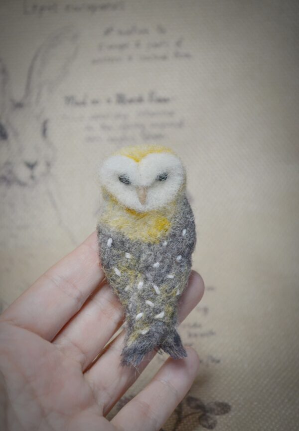 Handmade needle felted owl brooch. A unique wool accessory with secure pin, perfect for jackets, scarves, and as a gift for owl lovers.