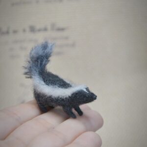 Handmade skunk miniature felted from natural wool. A charming woodland animal collectible for dollhouses, dioramas, and unique handmade gift lovers.