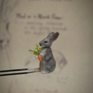 Adorable handmade needle felted bunny holding a carrot. Features movable head and limbs. A perfect miniature for collectors, dollhouses, and animal lovers.