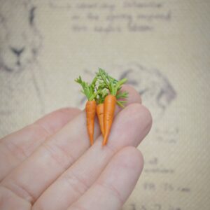 Set of three handmade polymer clay carrots with realistic detail. Perfect miniature props for dollhouses, dioramas, or needle felted animals.