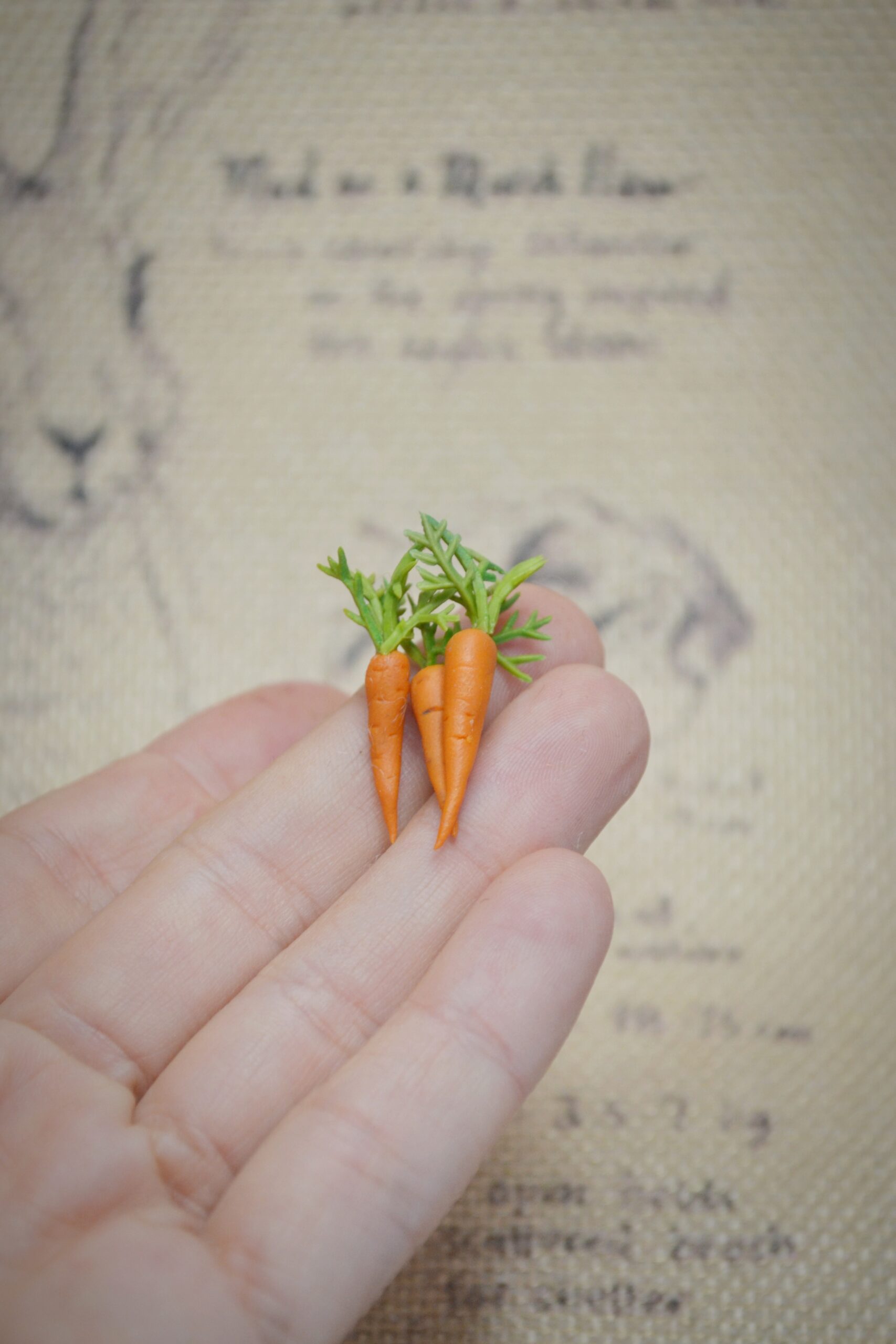 Set of three handmade polymer clay carrots with realistic detail. Perfect miniature props for dollhouses, dioramas, or needle felted animals.