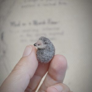 Tiny handmade needle felted hedgehog curled up into a ball. Perfect collectible wool miniature for dollhouses and woodland lovers.