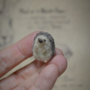 Tiny handmade needle felted hedgehog miniature. Perfect wool collectible for dollhouses, woodland scenes, and hedgehog lovers.