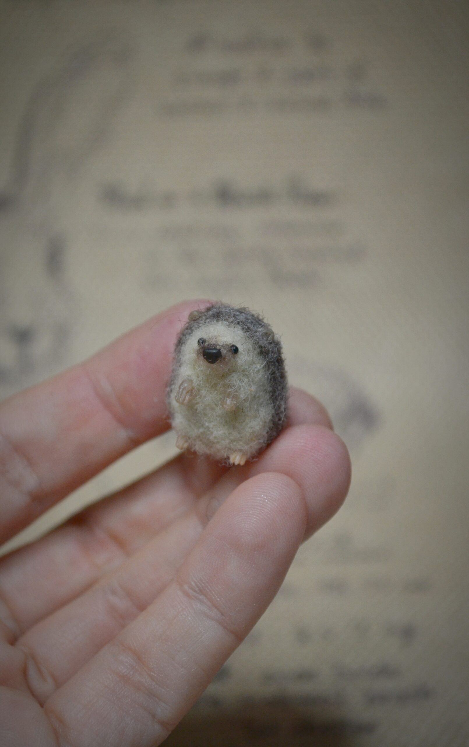 Tiny handmade needle felted hedgehog miniature. Perfect wool collectible for dollhouses, woodland scenes, and hedgehog lovers.