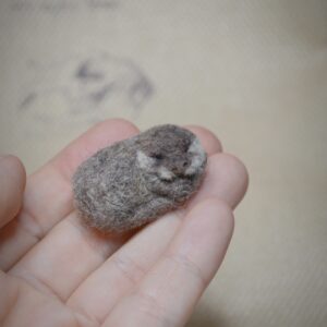 needle felted otter, felted animal miniature, sleeping otter, wool felt sculpture, tiny felted creature, handmade animal art, dollhouse decor, woodland collectible, felted wildlife, wool miniature art
