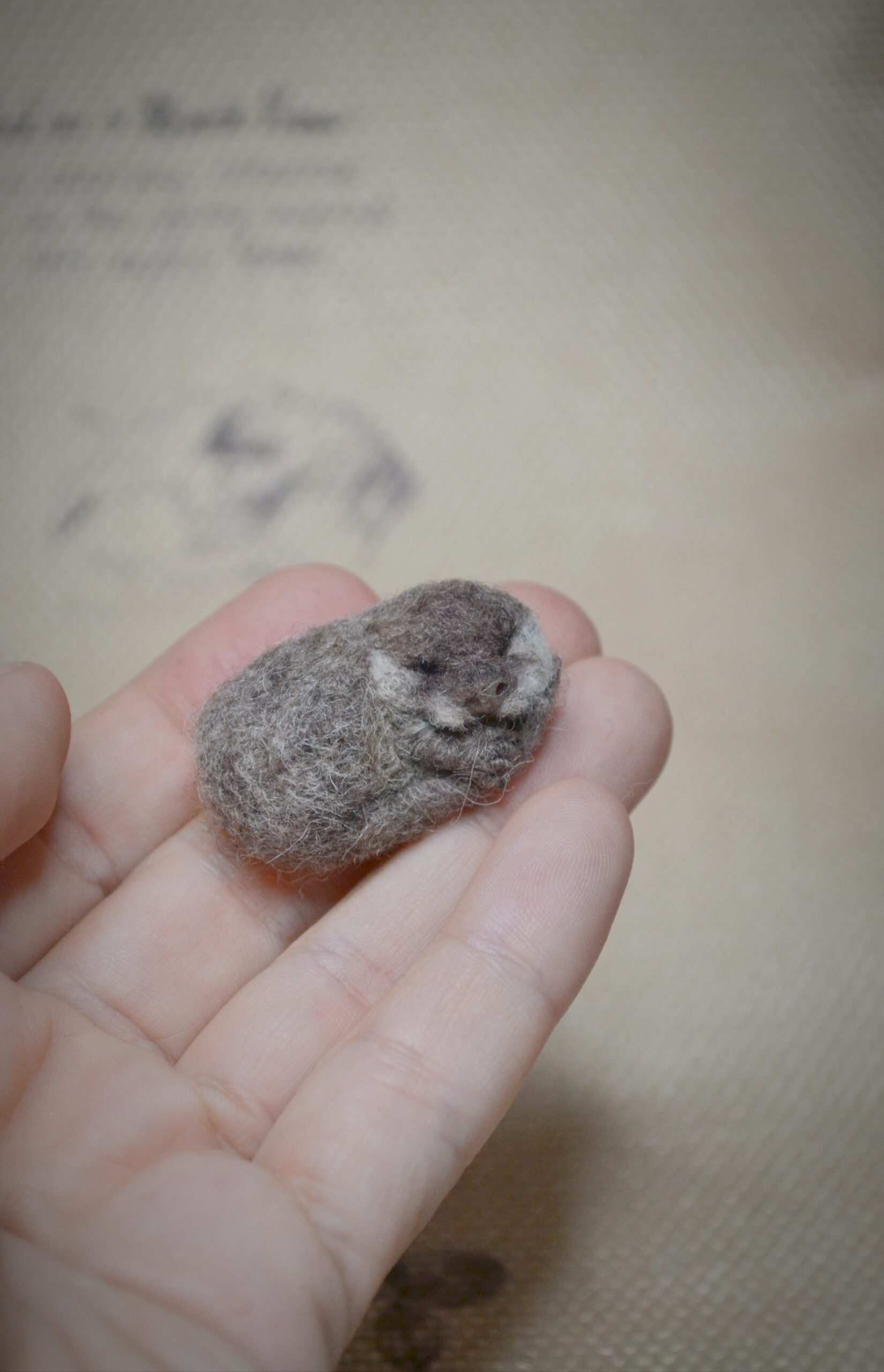 needle felted otter, felted animal miniature, sleeping otter, wool felt sculpture, tiny felted creature, handmade animal art, dollhouse decor, woodland collectible, felted wildlife, wool miniature art
