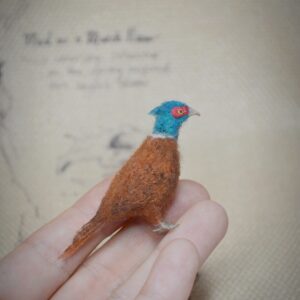 Handmade needle felted pheasant miniature crafted from natural wool with rich colors and detailed textures.